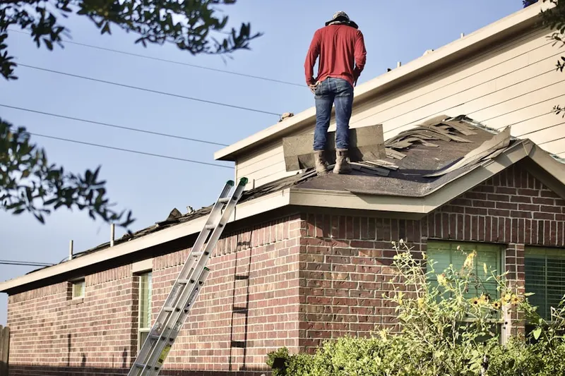 Professional roofer working on a residential roof in Verona